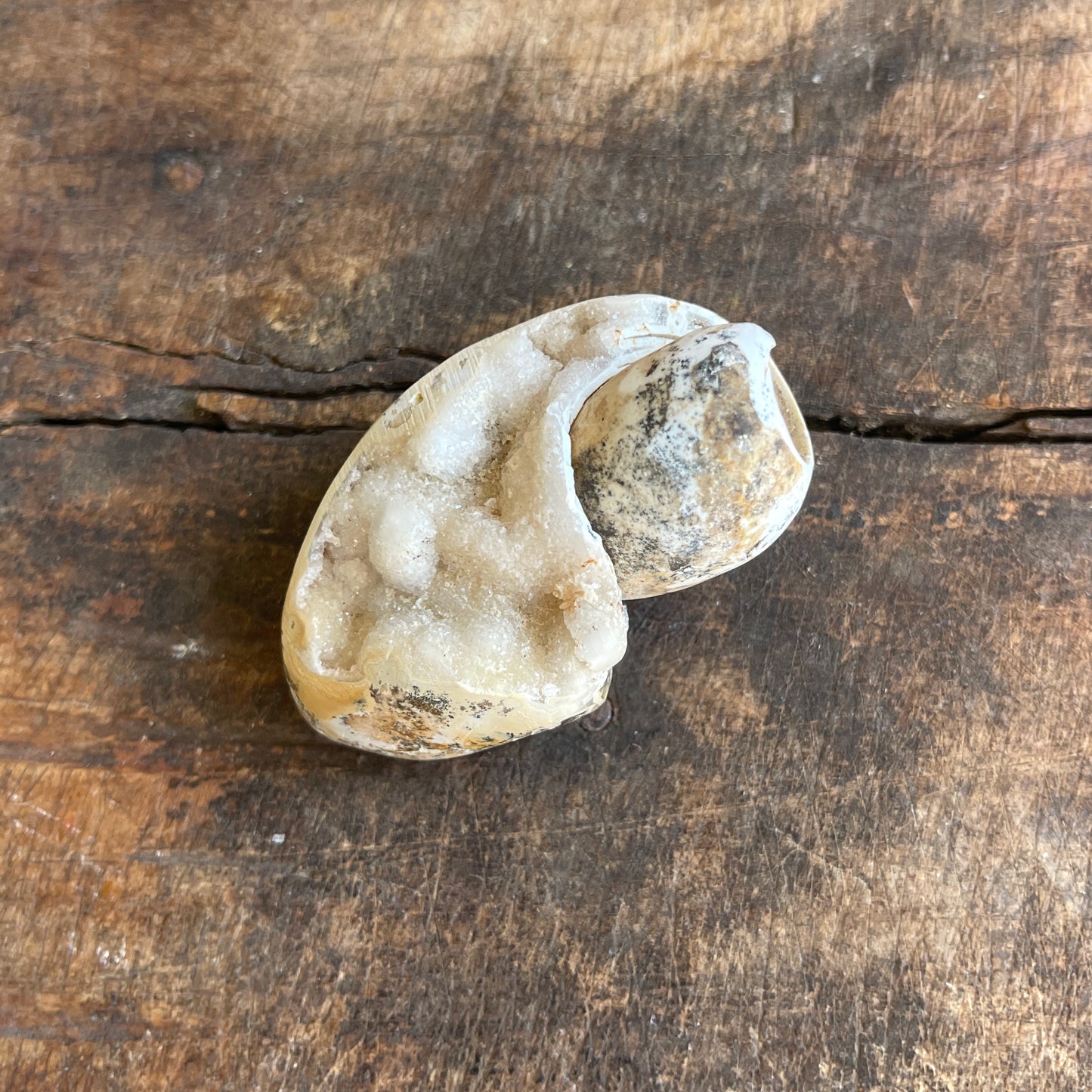 Geode split open on a wooden surface