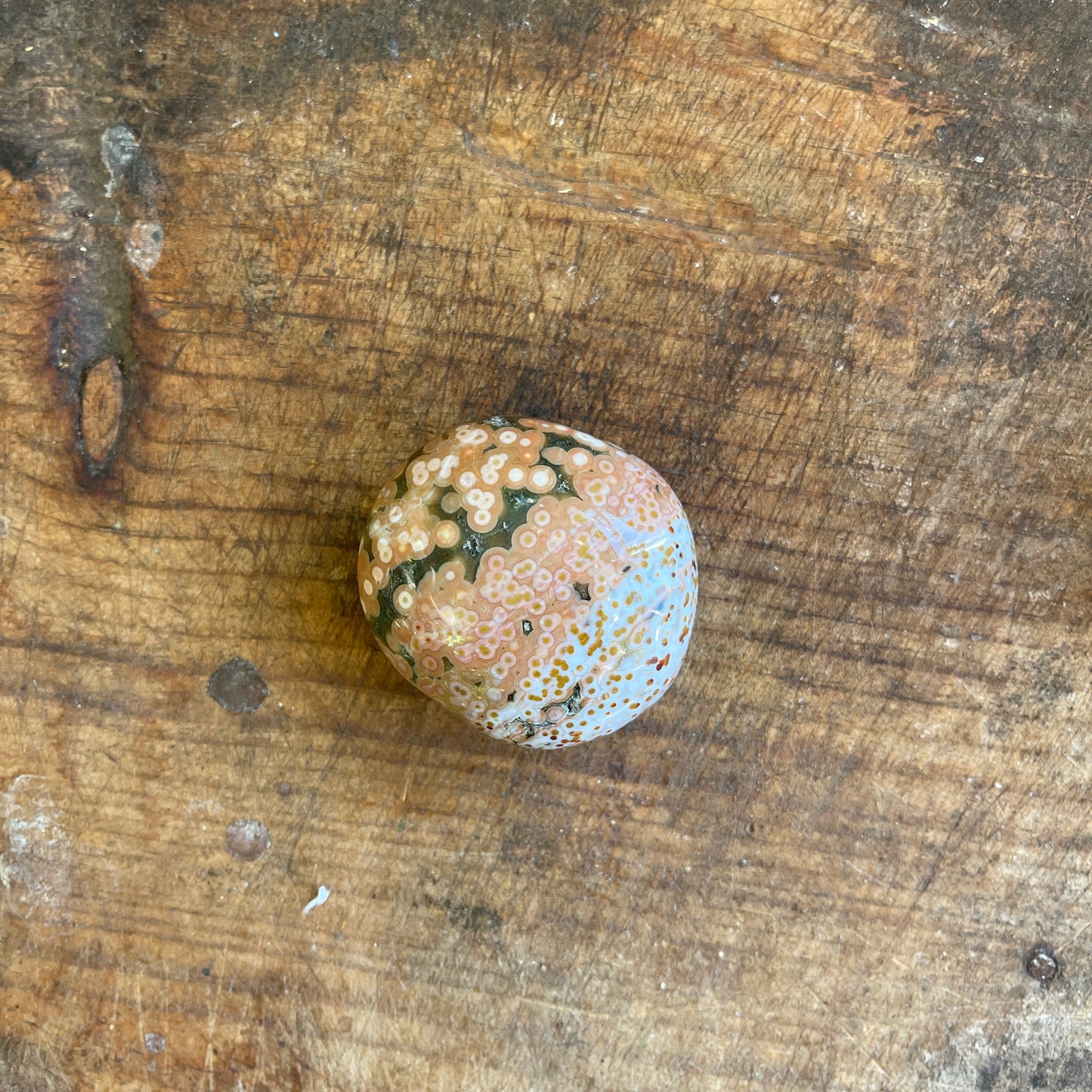 Decorative stone with a textured surface on a wooden background