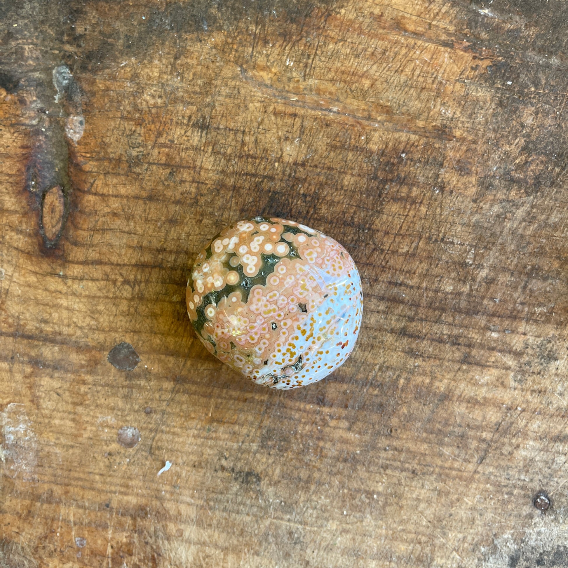 Decorative stone with a textured surface on a wooden background