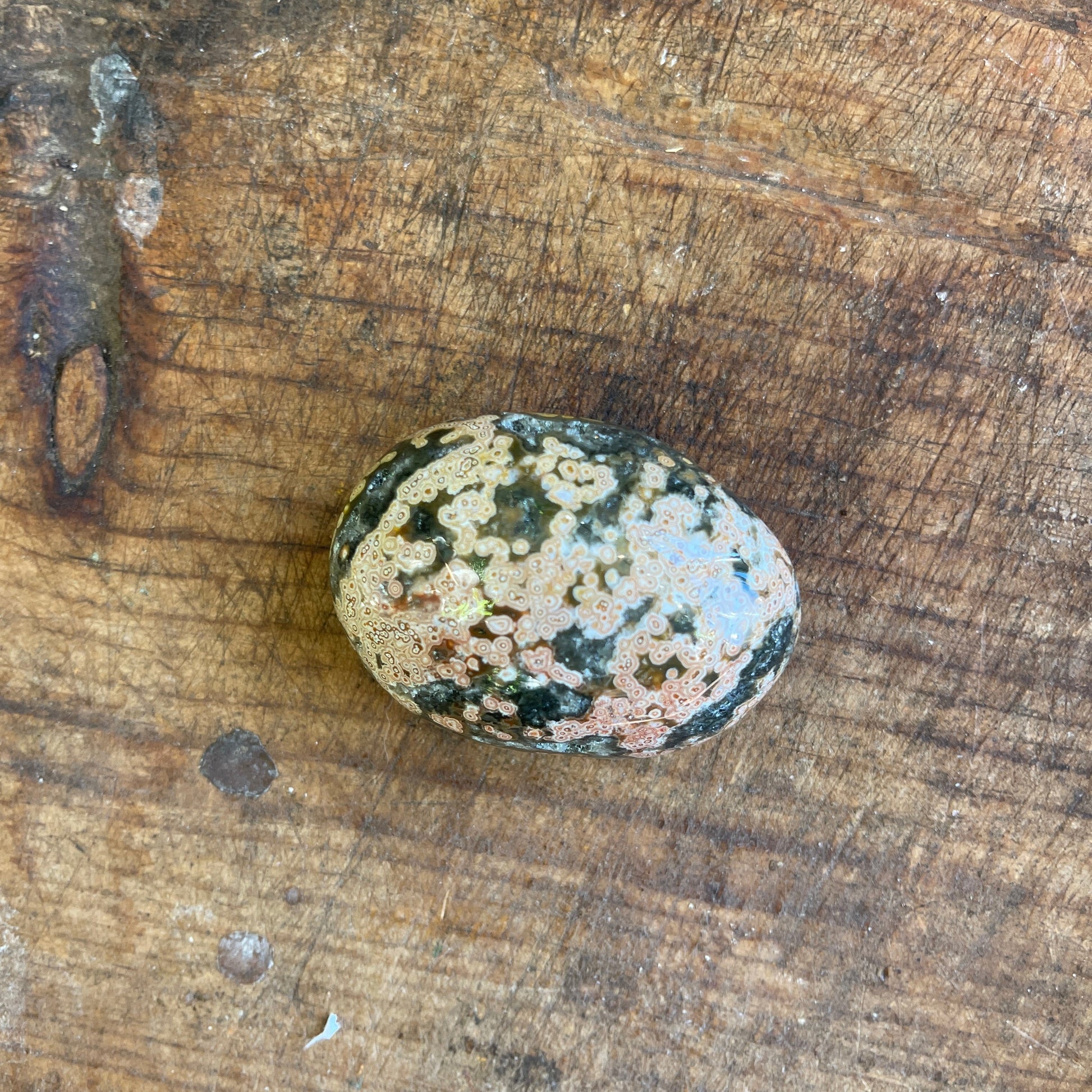 Polished stone on a wooden surface