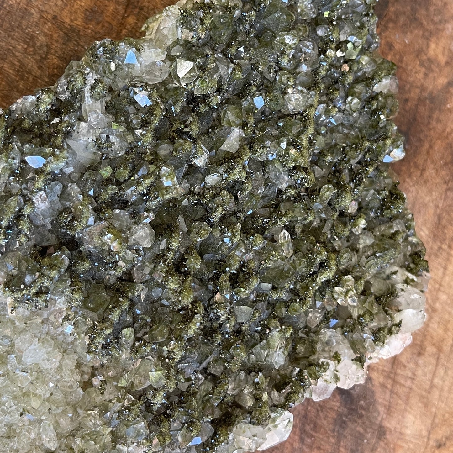 Close-up of a crystal cluster on a wooden surface