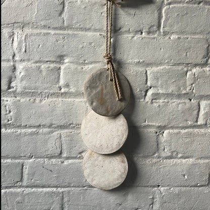 Wall hanger made from 3 ceramic discs, strung from rope