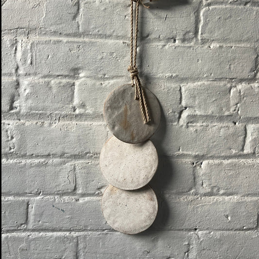 Wall hanger made from 3 ceramic discs, strung from rope