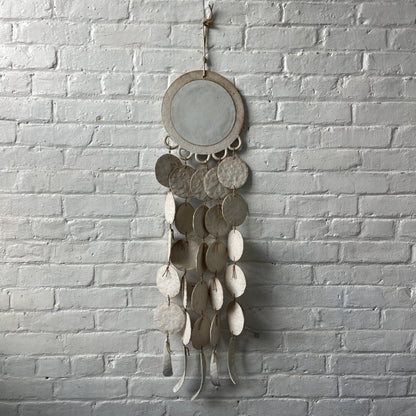 White ceramic dreamweaver against white brick wall