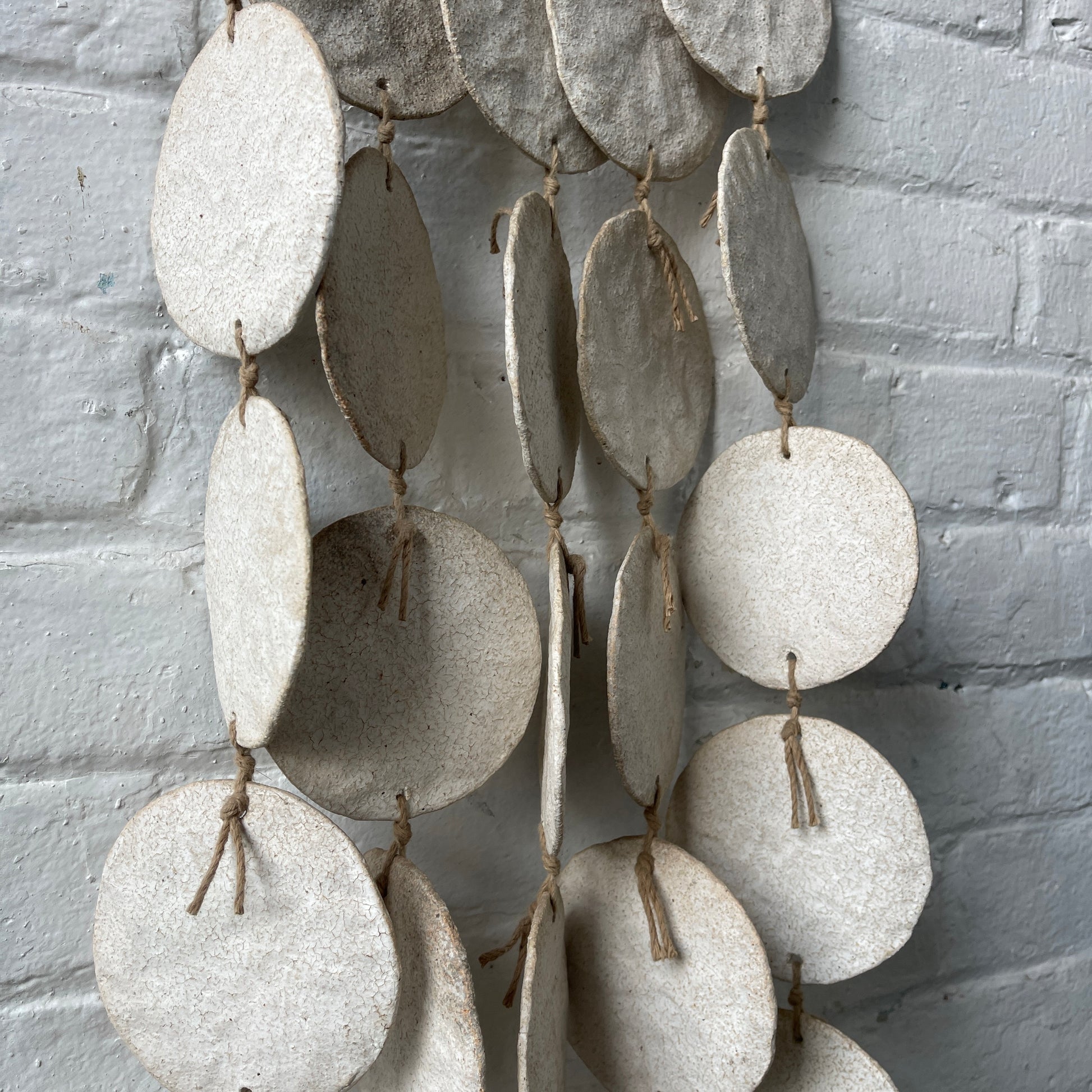 White ceramic dreamweaver against white brick wall