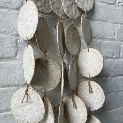 White ceramic dreamweaver against white brick wall