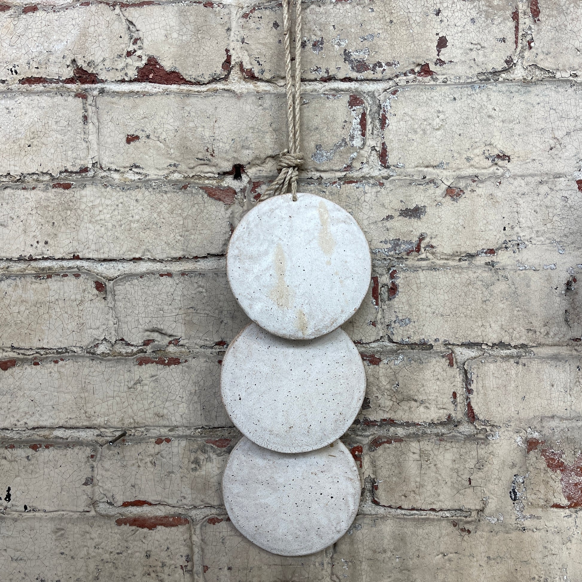 Wall hanger made from 3 ceramic discs, strung from rope