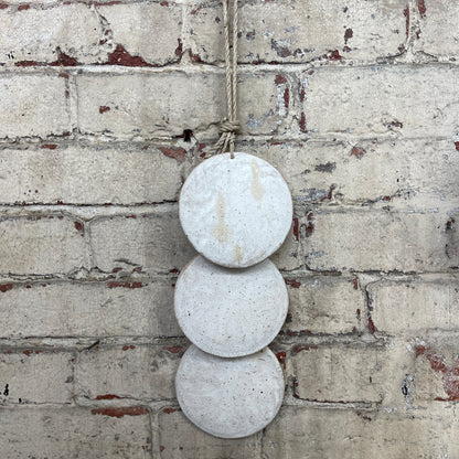 Wall hanger made from 3 ceramic discs, strung from rope
