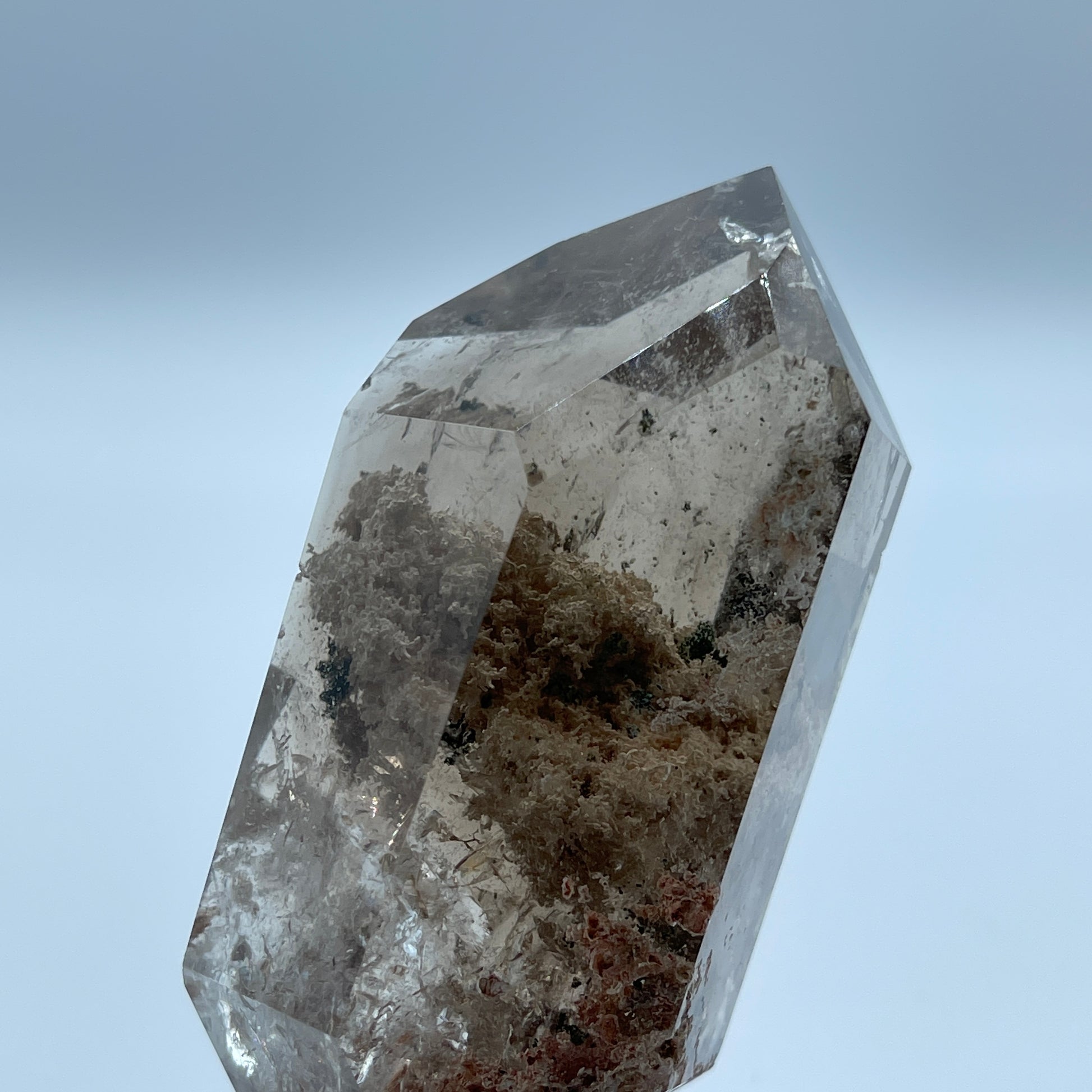 Crystal with a rough, natural surface on a light blue background