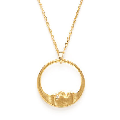 Gold necklace with a circular pendant on a white background