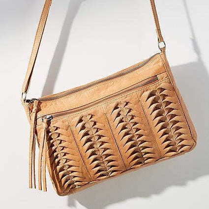 Brown leather handbag with a textured pattern on a white background