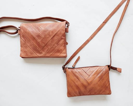 Two brown leather crossbody bags with a chevron pattern on a white background