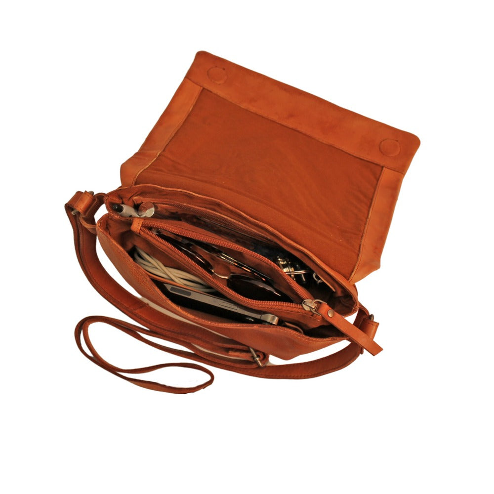 Brown leather handbag with a strap on a white background