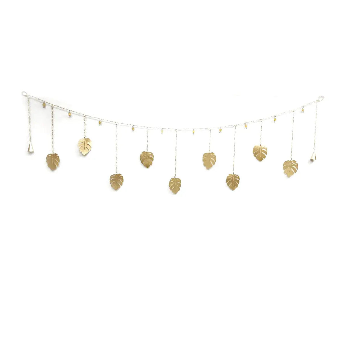 A gold-toned leaf garland with multiple hanging monstera leaf charms suspended from a thin wire frame, shown against a plain white background.