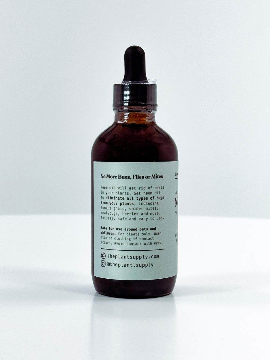 An amber glass dropper bottle with a black rubber dropper cap and a white label, photographed on a clean white background. The label text is partially visible, showing the brand name 'The Plant Supply'.