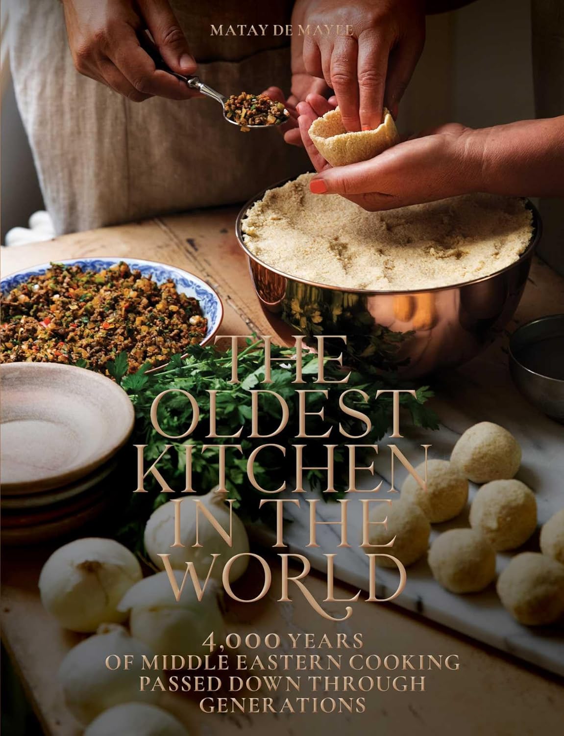 Book cover of 'The Oldest Kitchen in the World' with cooking scene and text.