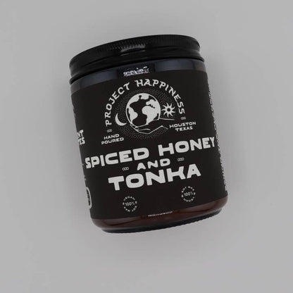 'Spiced Honey and Tonka' candle by Project Happiness on a gray background