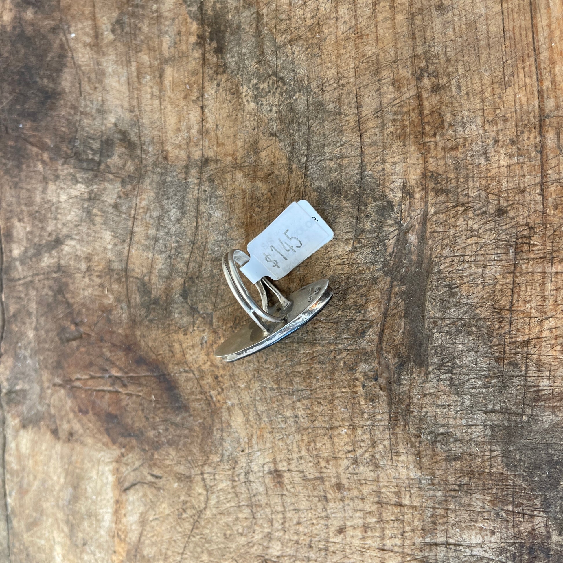 Ring with a tag on a wooden surface