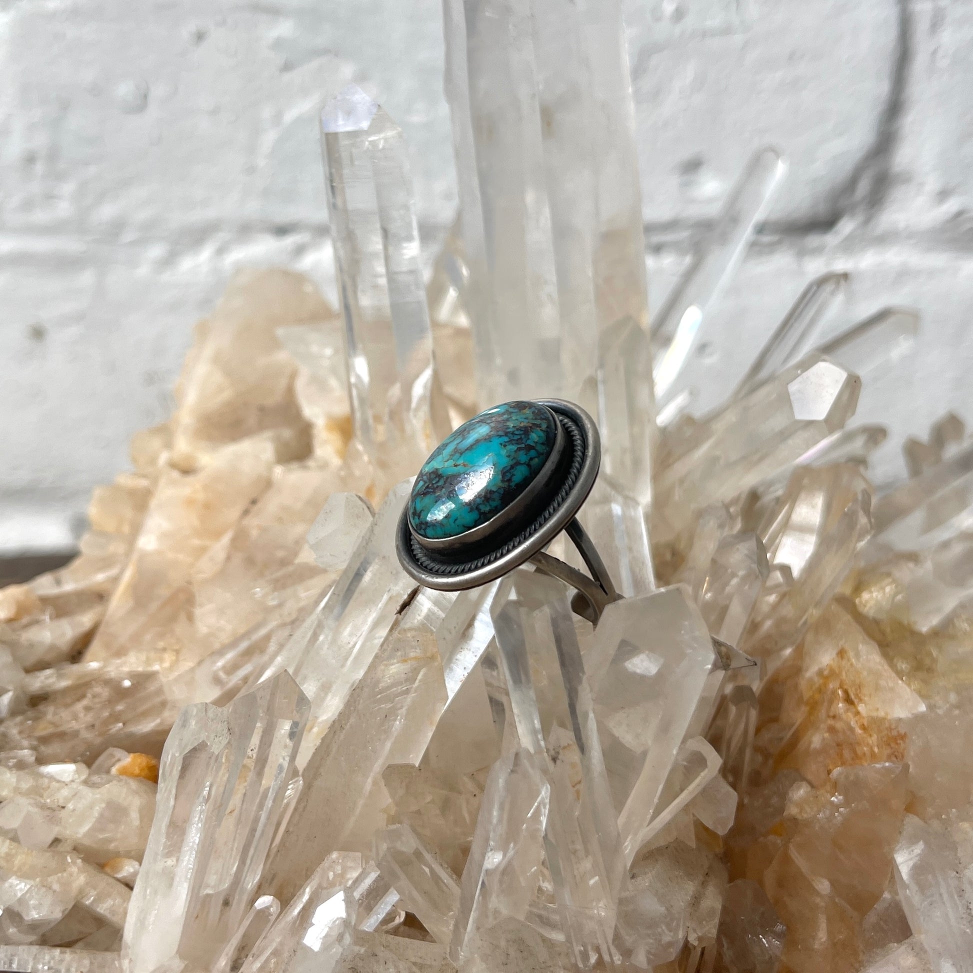 Turquoise stone ring on a crystal background