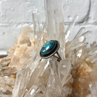 Turquoise stone ring on a crystal background
