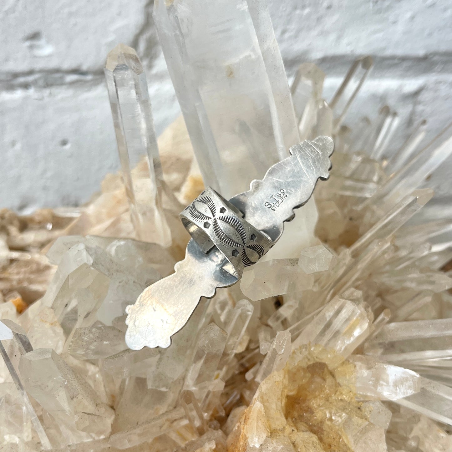 Back of sterling silver ring on a crystal background