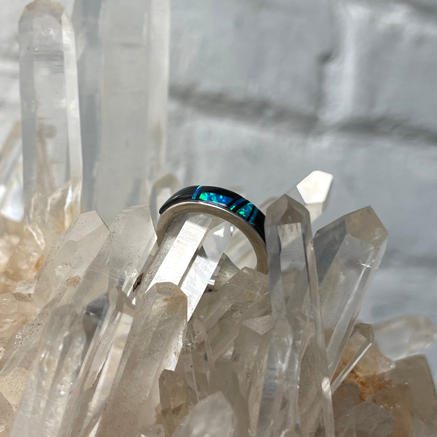 Ring with opal and onyx inlay on clear crystal background