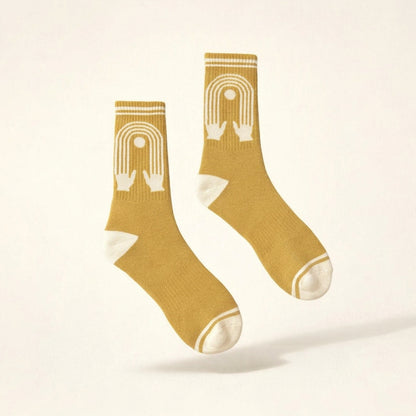 a picture of Yellow Socks with a design of hands reaching into connected fingers with white toes. 