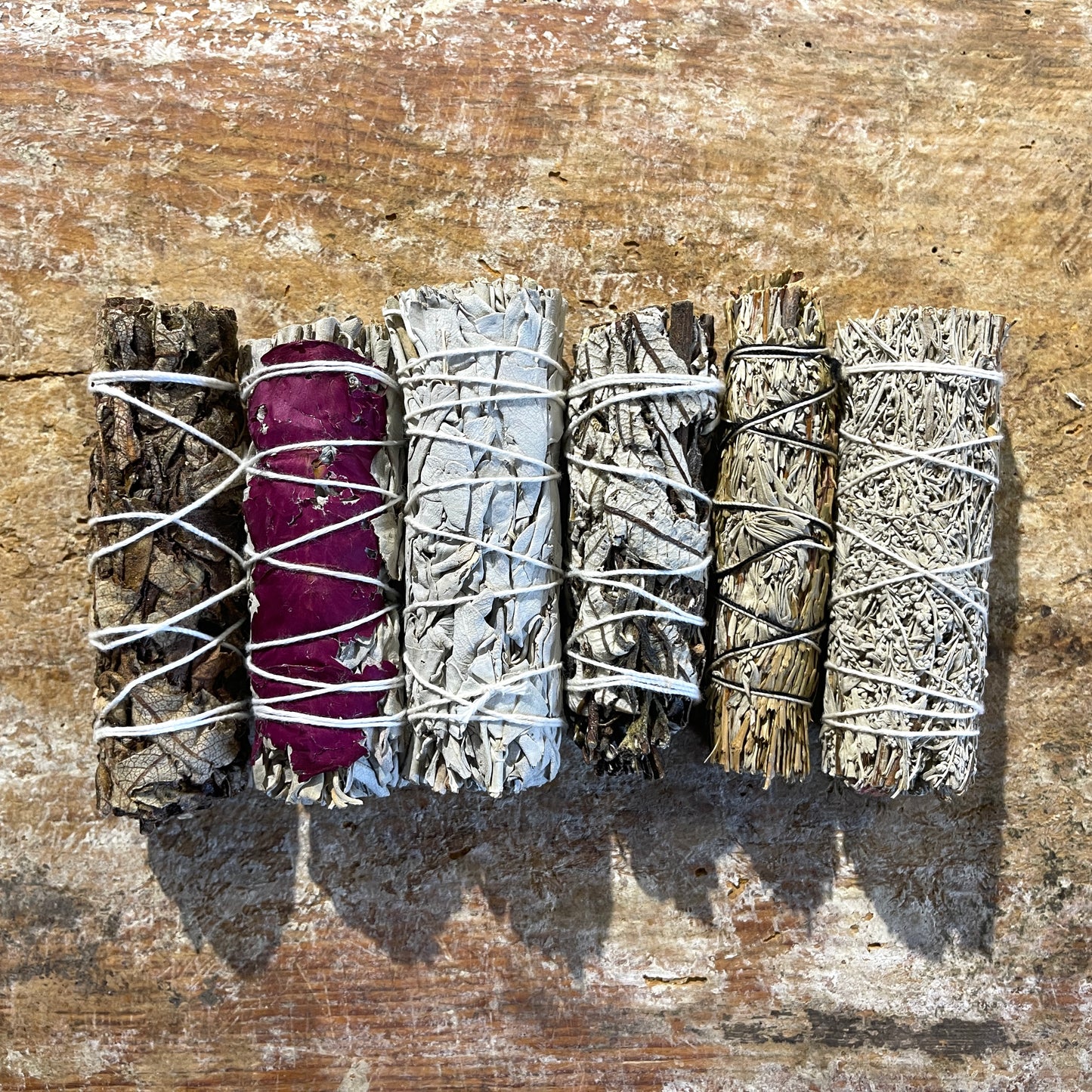 Set of smudge sticks on a wooden surface
