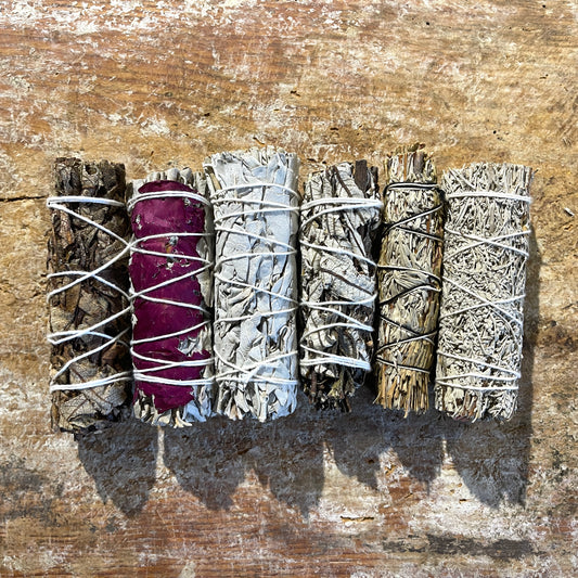 Set of smudge sticks on a wooden surface