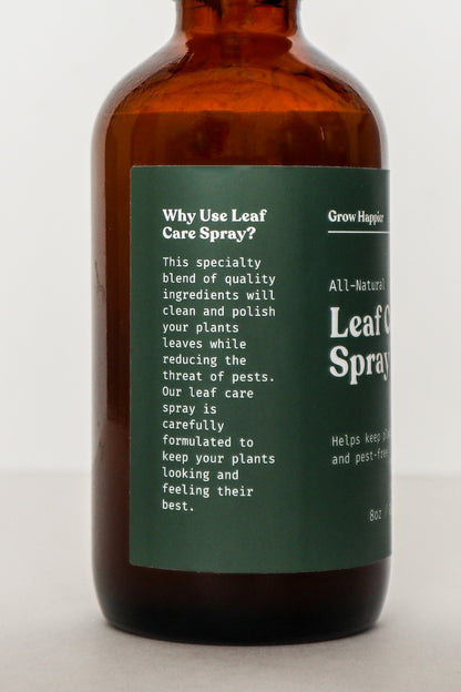 Brown bottle of 'Leaf Care Spray' with a green label on a white background