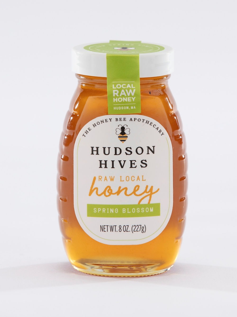 Jar of Hudson Hives honey with a green label on a white background