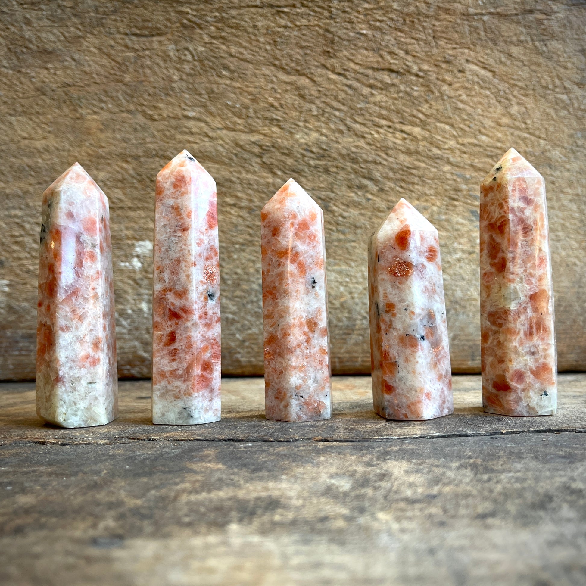Sunstone points on a wooden surface