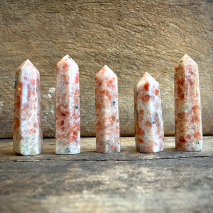 Sunstone points on a wooden surface