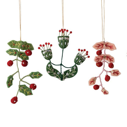 Three decorative hanging ornaments shaped like winter botanical designs