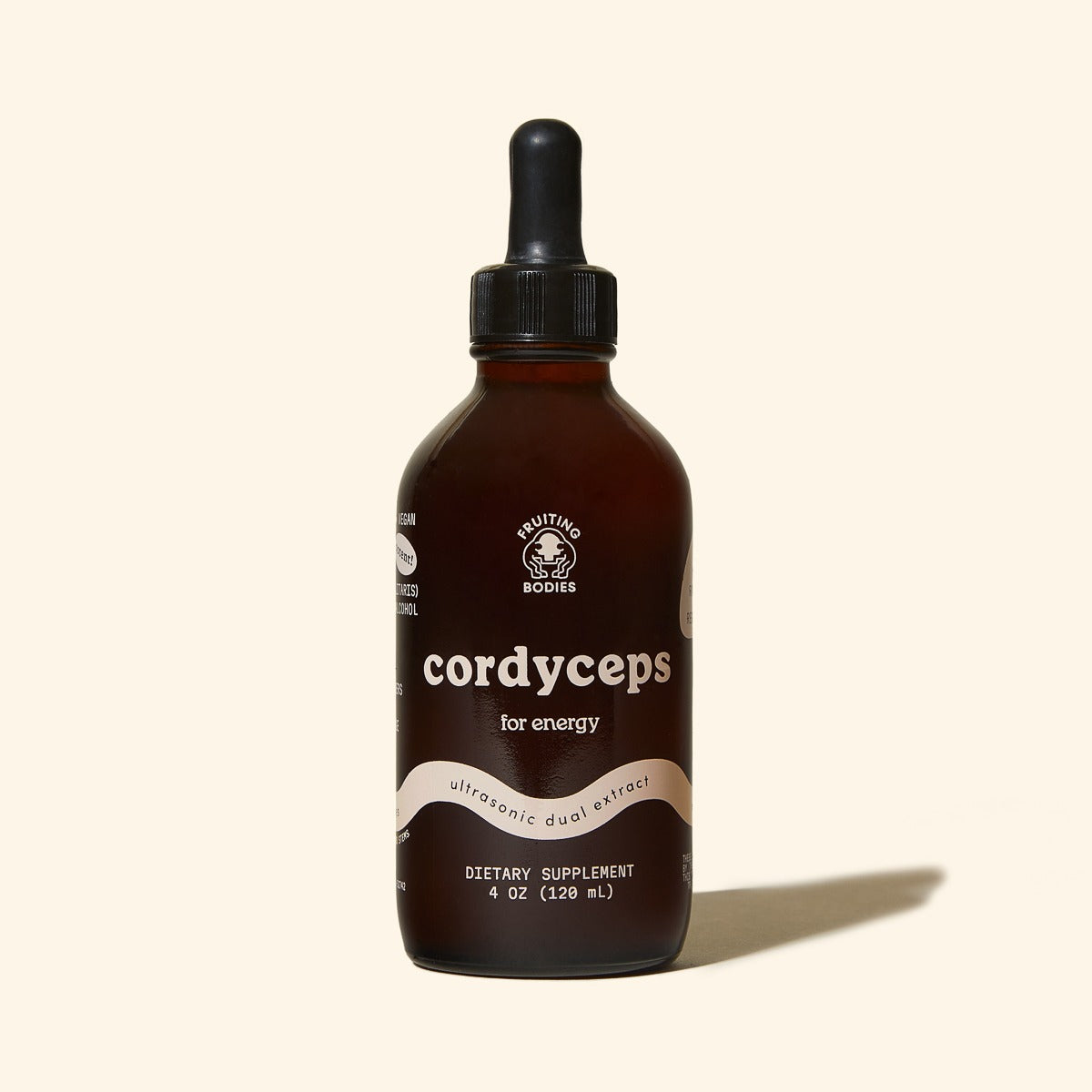 Bottle of cordyceps dietary supplement with dropper on a beige background