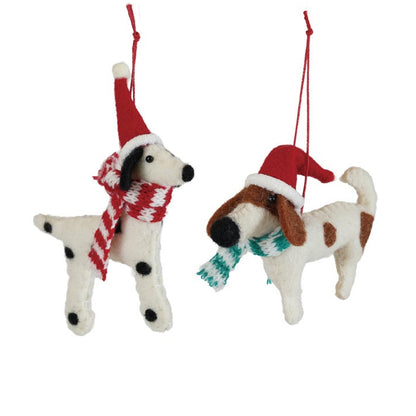 Two dog-shaped Christmas ornaments wearing Santa hats and scarves on a white background