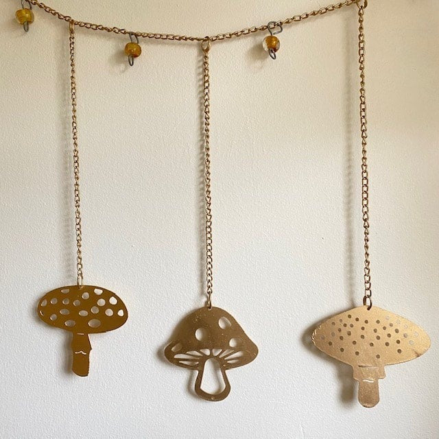 A decorative garland with gold mushrooms and gold beads