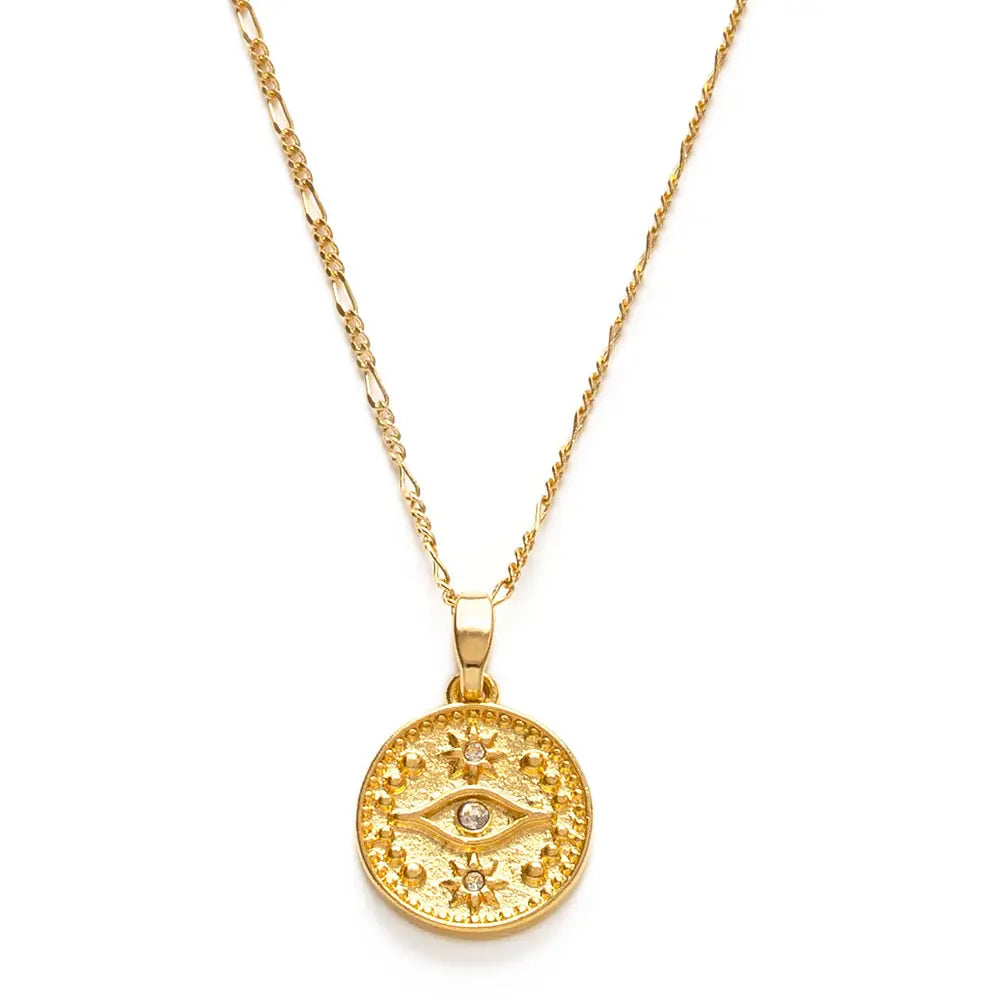 Gold necklace with a round pendant featuring an eye design on a white background