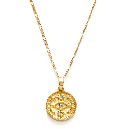 Gold necklace with a round pendant featuring an eye design on a white background