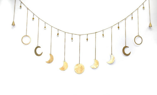 A decorative garland made of metal in the shape of moons and circles, strung together with a protective color layer.
