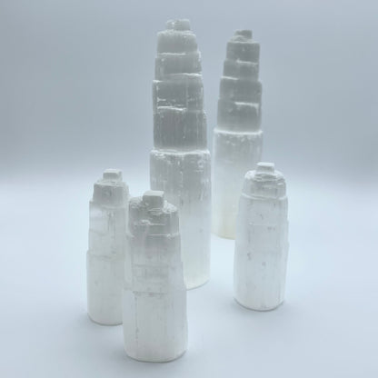 5 selenite towers on grey background