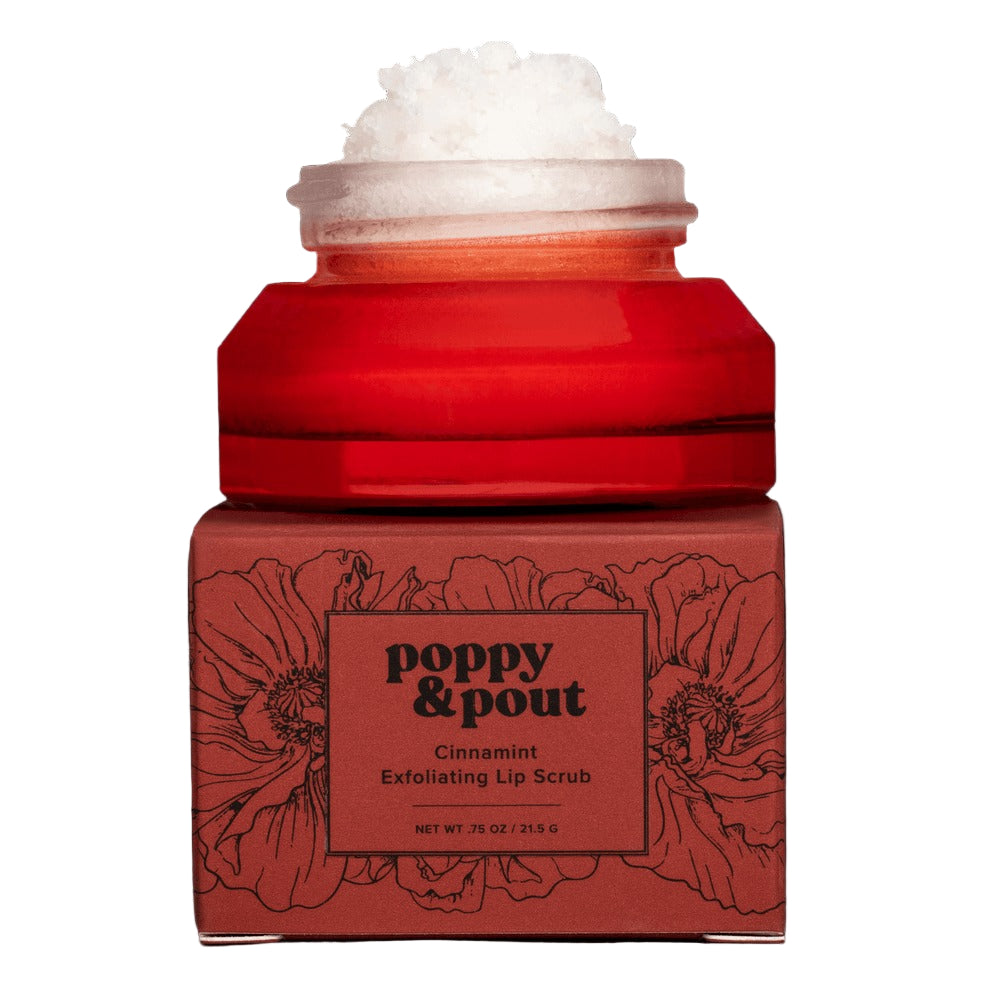 Red jar of Poppy & Pout cinnamon lip scrub with floral design on a black background