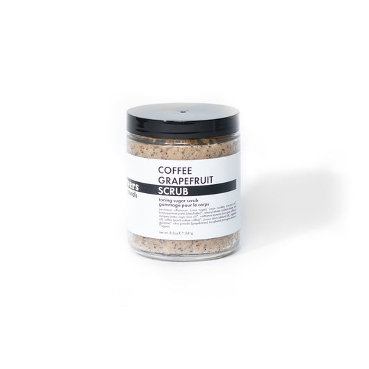 Jar of coffee grapefruit scrub with a black lid on a white background