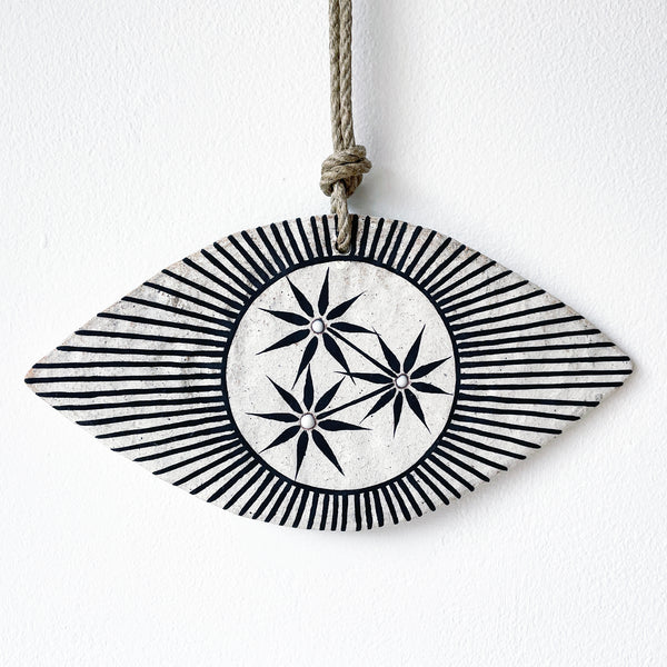 Ceramic eye shaped wall hanger with black and white design