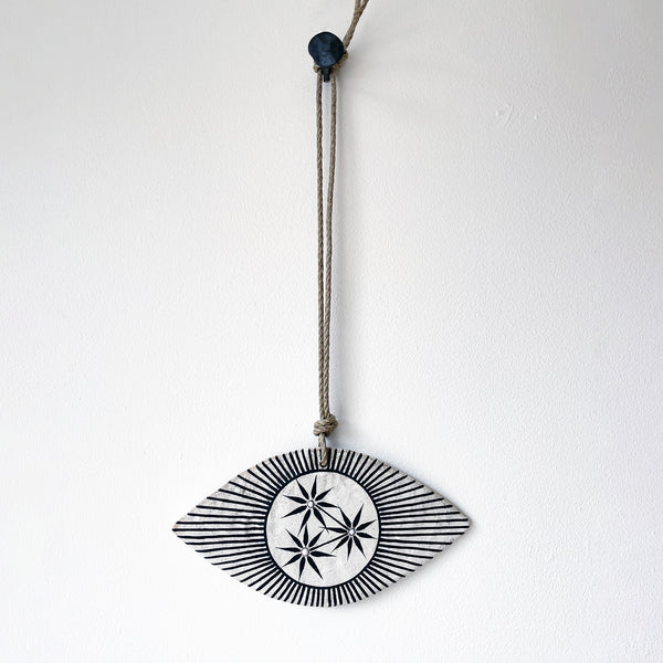 Ceramic eye shaped wall hanger with black and white design