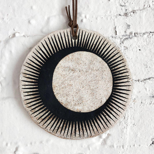 Ceramic wall hanger with black sun and crescent design