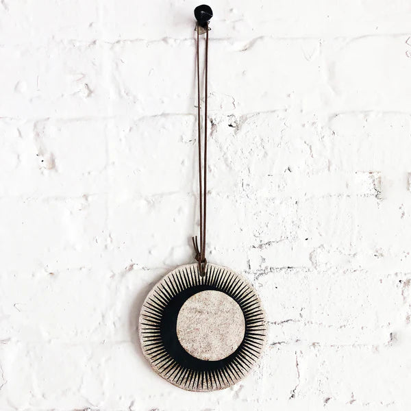 Ceramic wall hanger with black sun and crescent design