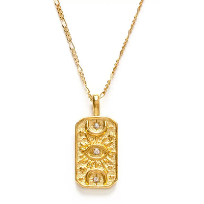 A gold rectangular pendant necklace featuring three stacked eye motifs with small clear gemstones, suspended from a gold chain on a white background.
