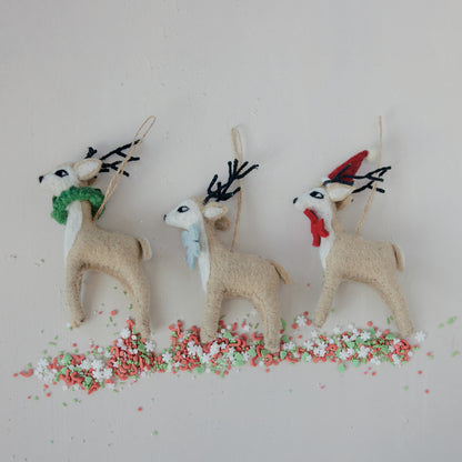 3 reindeer ornaments over holiday confetti 