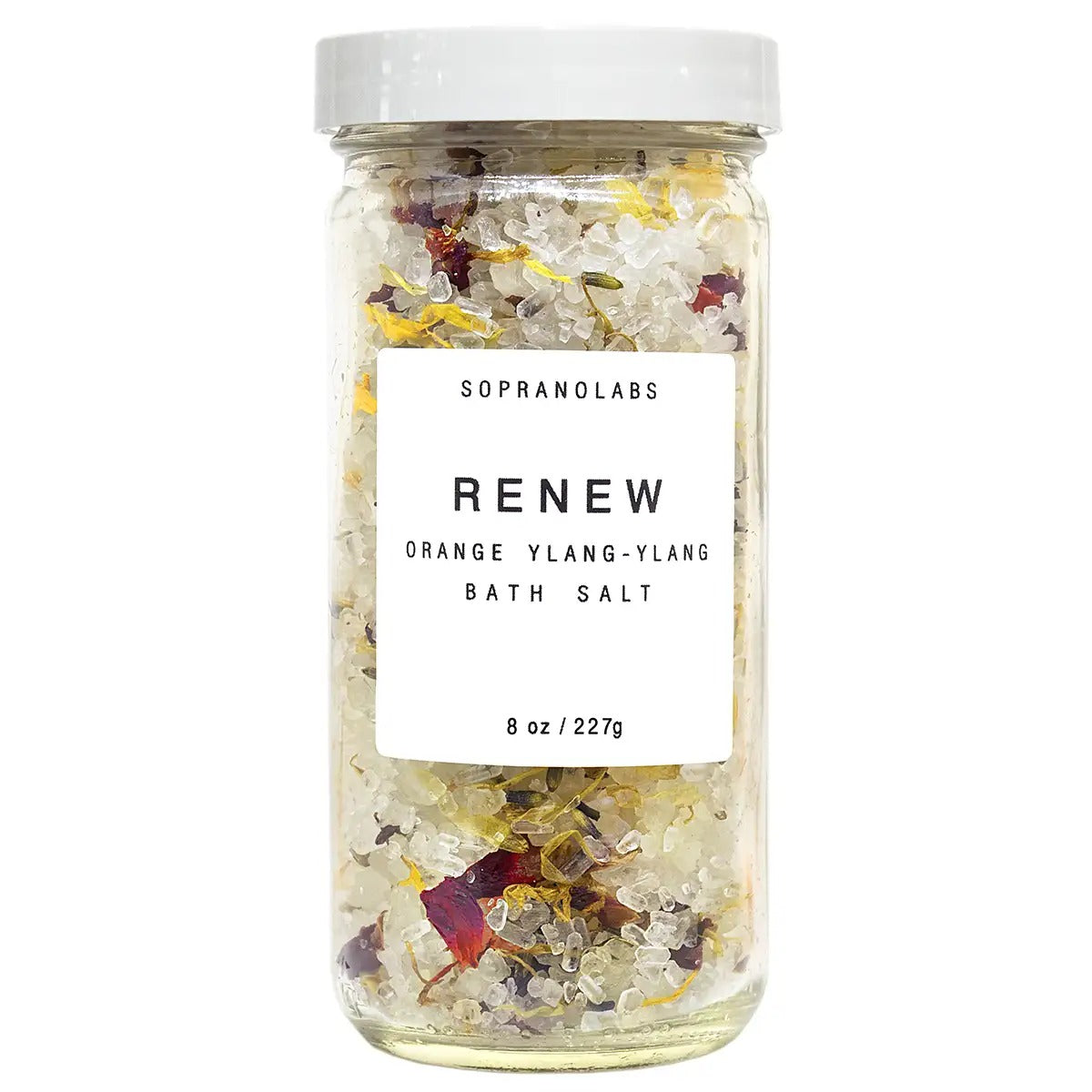 Jar of bath salts labeled 'Renew' with visible ingredients on a white background